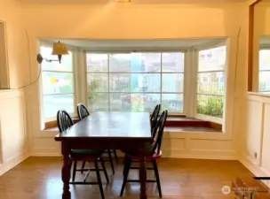 Lovely bright dining room with wainscotting and big bay window seat make this a wonderful place to gather and entertain!