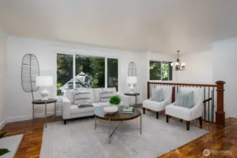 Large window in living room oversees the well maintained front yard.