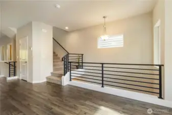 Open second-floor landing with stairs leading to the third floor.