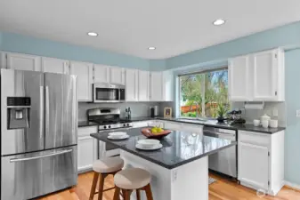 Kitchen with granite counters and stainless steel appliances.