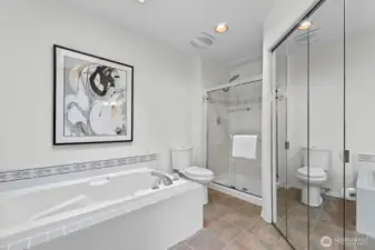 Primary suite bathroom with soaking tub and separate shower.