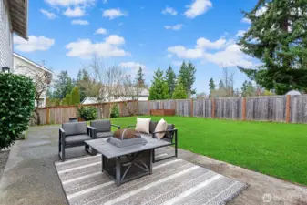 Large patio in the level rear yard.