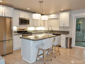 Stylish Kitchen w/ Island, Quartz counters, SS Appliances, Propane Range, and lots of lighting.