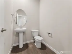 Main level powder room.  Actual home is under construction and materials, colors, and finishes will vary. See site agent for details.