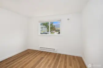 The second of two bedrooms has a south facing window that fills the space with light.  New hard surface LVT flooring.