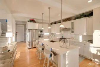 Beautiful appliances, a coffee station, a 36" range and a walk-in pantry make this space perfect for entertaining a large group. In the back hall, there is a laundry room and powder bath.  There is also a back door that leads to the hot tub and carriage house.