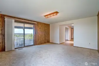 Another view of the room to the left of the entry way and deck access.