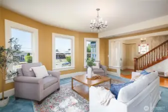 Another view of the light-filled formal living room and welcoming entry.