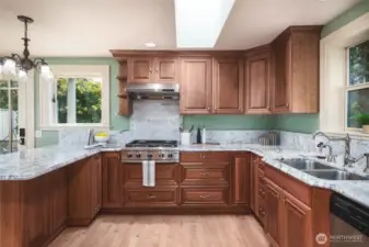 Updated chef's kitchen offers stunning marble counters and backsplash, cherry cabinets, stainless appliances and wood flooring.
