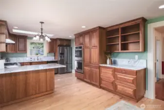 Updated kitchen with breakfast bar, tons of storage and prep space, marble counters and backsplash, pantry, double oven and tons of prep space. Invite your guests, it's time to entertain!!
