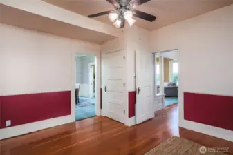 Family room/den with wood floors, opening to the entry, dining and kitchen.