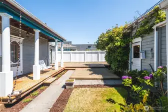 Private fenced back yard with spacious deck for outdoor enjoyment. Even a porch swing! On the right is the shop/hobby room, with entry to an additional storage room and one car garage.