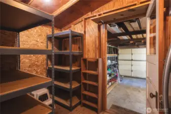 Storage room with lots of shelving and a refrigerator to keep your cold drinks!