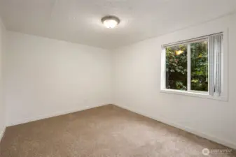 Bedroom two with private garden window.
