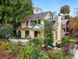 A timeless Leschi residence blending Craftsman warmth with Colonial Revival symmetry, surrounded by lush Northwest landscaping and mature evergreens.