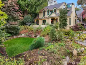 Surrounded by curated gardens and native plantings, the property’s design celebrates nature, privacy, and Northwest beauty year-round.  The private lawn setting sits above the street and is made even more private from Spring to early Fall with tall plant barriers.