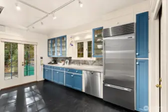 The chef’s kitchen combines timeless design and modern performance with a Miele steam oven, Gaggenau oven, Sub-Zero refrigeration, and glass-front cabinetry.  The view out the kitchen window is 100% nature!