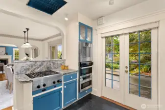 The kitchen’s professional-grade range and granite counters open to French doors and a deck surrounded by gardens—perfect for effortless indoor-outdoor dining.  Stay connected to your guests as you cook up something fantastic!