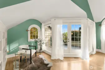 The French doors lead to the rooftop deck where you can relax amongst the canopy of trees.  Just to the left, a serene corner for reflection or reading featuring built in shelves.