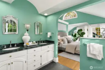 Dual vanities with vintage-inspired mirrors, and arched architecture complete this serene and sophisticated ensuite.  Reveal:  the sinks here have a dedicated on-demand water heater.