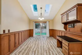 On the opposite side of the kitchen is ample space for a breakfast nook, with skylights and access to the backyard.