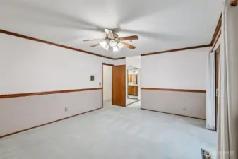 Another view of the primary bedroom with ensuite bathroom.