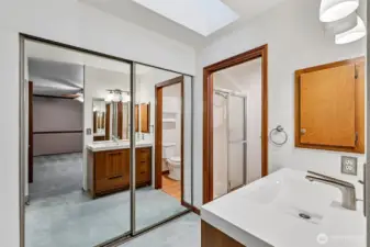 Ensuite bathroom with new vanity, and two closets. The toilet and shower have a pocket door for privacy.