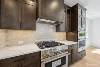 gas stove/range and full height tile backsplash.