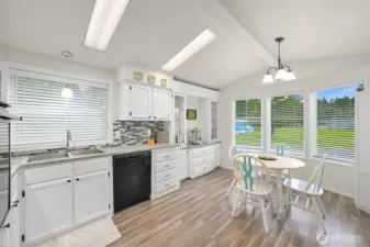 Bright kitchen has newer fridge and dishwasher.