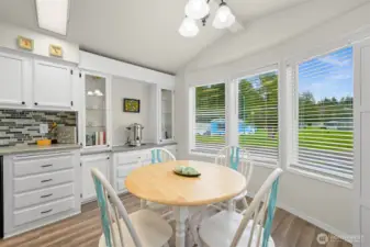 Sunny dining area with charming hutch.