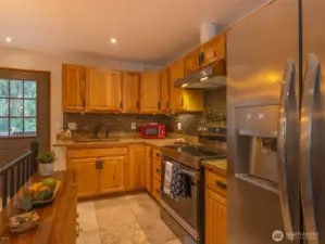 Nice cabinetry compliment the rich granite tones and backsplash.