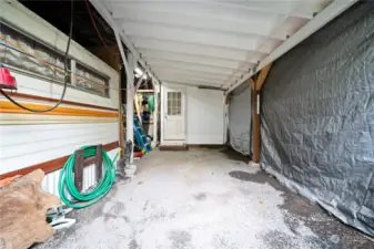 Covered storage area with built in Storage. Utility Room.