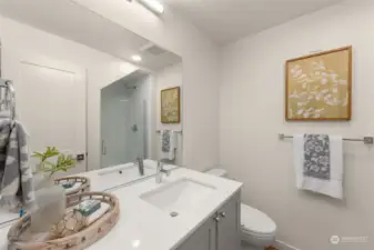 This bathroom is thoughtfully designed with sleek finishes—an excellent space for guests or family.