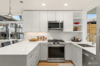 Step into a culinary dream! This sleek and modern kitchen boasts pristine quartz countertops, stainless steel appliances, and a thoughtfully designed layout for effortless cooking and entertaining.