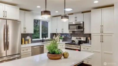 Enjoy ample cabinet space and pantry in this kitchen.