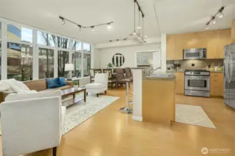 Stainless steel appliances and modern lighting make the kitchen sparkle