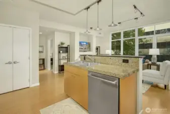 Hall to a second bed and bath is seen to the left of the fireplace.