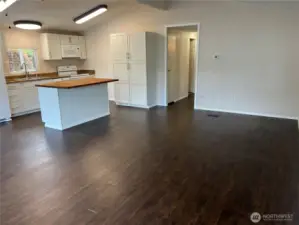 View of dining area and kitchen from living area.