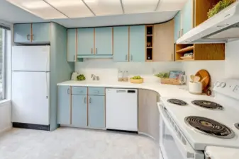 The open kitchen with windows and sliding door offers lots of light.