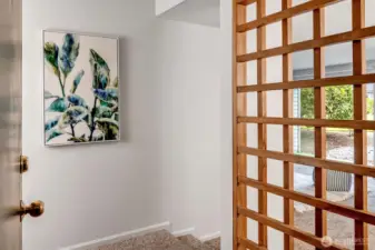 Welcoming entry with wood screen buffer between the entry and main living areas