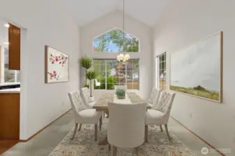 GRACEFUL DINING AREA WITH SOARING VAULTED CEILINGS AND BRIGHT WINDOWS.