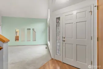 WELCOMING FOYER, WITH VAULTED CEILINGS AND EASY ACCESS UPSTAIRS.