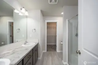 Primary ensuite with dual sinks, full shower and walk in closet