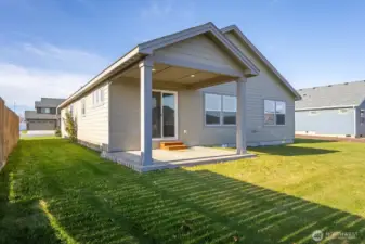 Back of home with upgraded covered patio