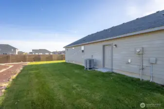 Side yard with door leading into garage