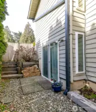 The side yard along the garage has a gravel path with stepping stones leading to the side patio and door to enter the lower level rec room which would be perfect to convert to an apartment or a second suite.