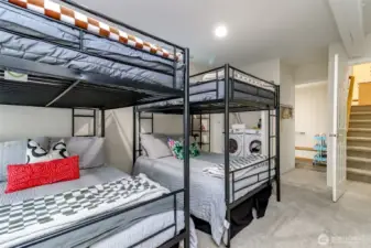 Here is another view of the ground level rec room with the 1/2 bathroom and laundry closet pictured behind the bunk beds.