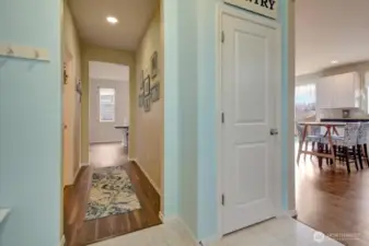 Hallway from mud room that leads back to the front door and past the half bath.