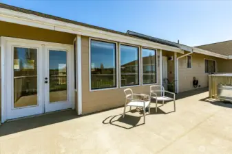 French doors from the living room provide additional access to deck and, when open, create an expansive indoor/outdoor living space