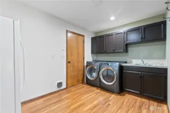 Dedicated laundry space also serves as mudroom entrance to garage and pantry.
